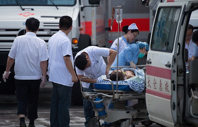 1406971249179 wps 1 Doctors and nurses rush a